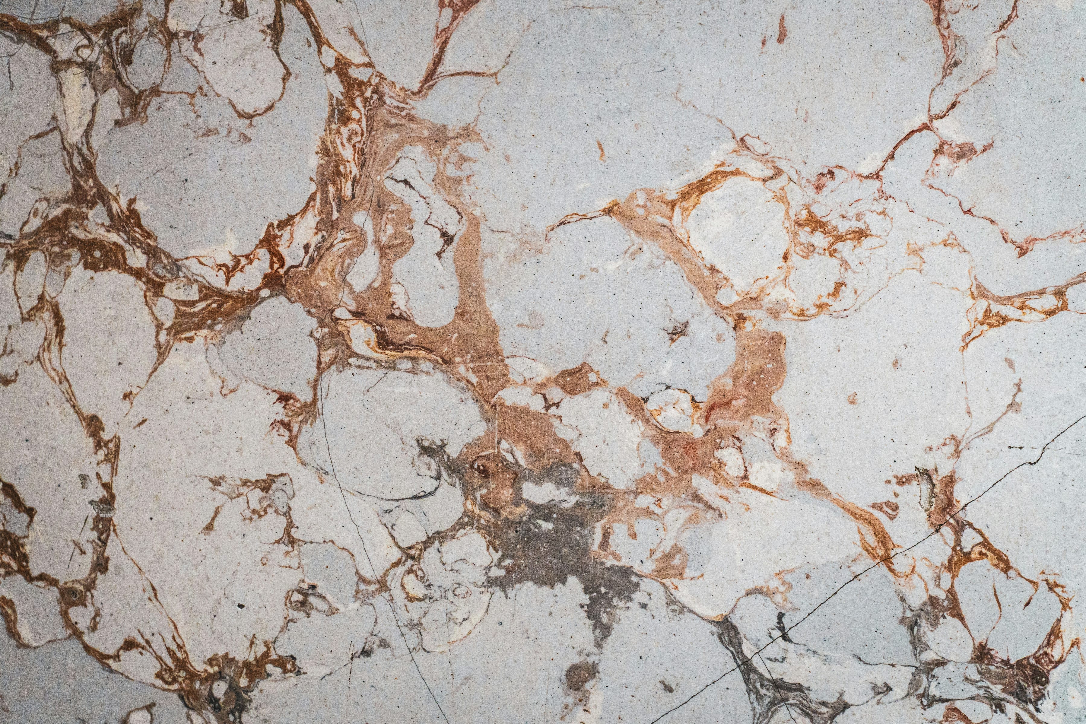 White surface in a marble look, with brown and grey veins