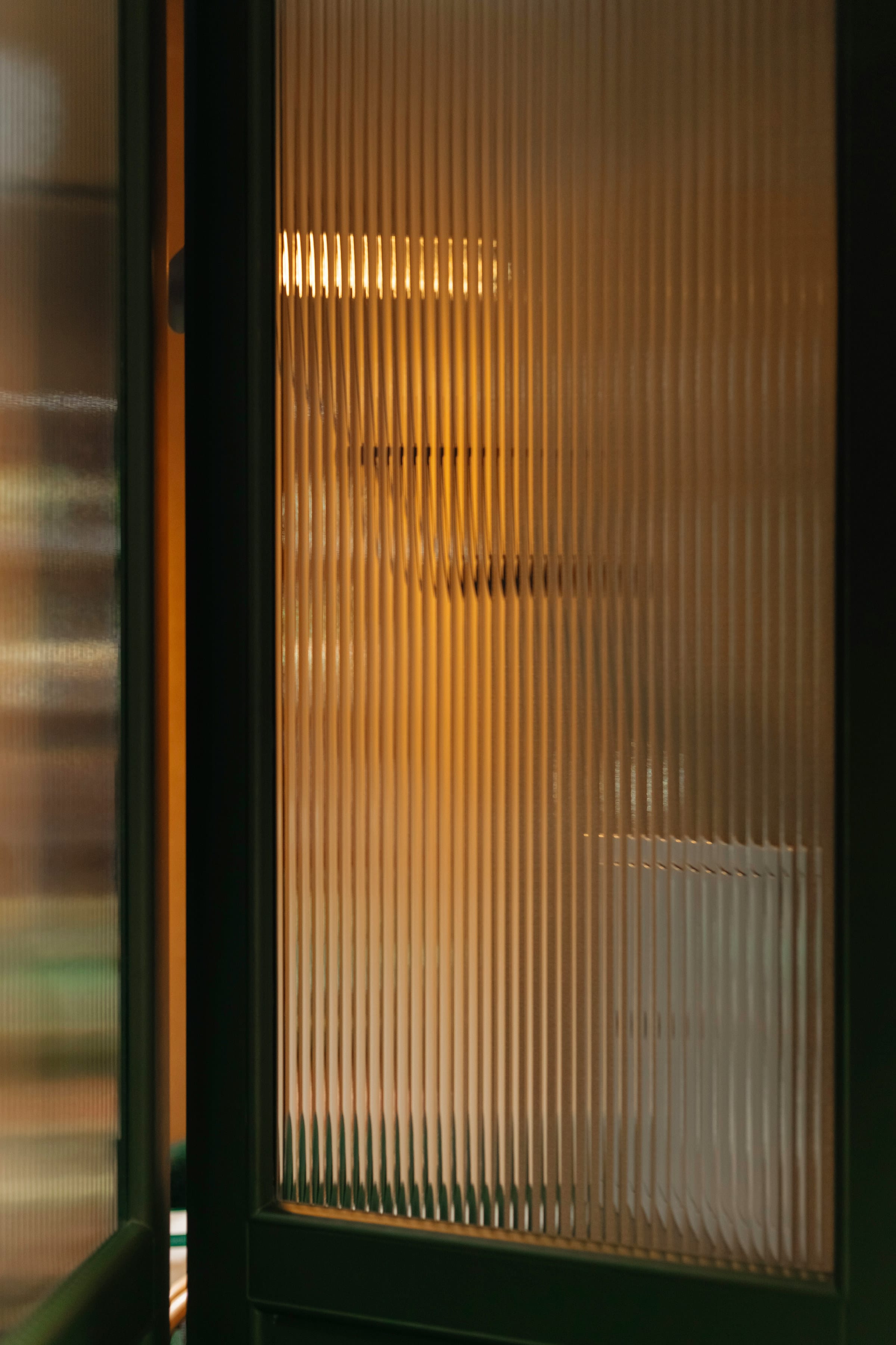 Amber fluted glass cabinet door with warm light behind